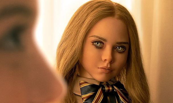 A doll with large blue eyes staring off into the distance